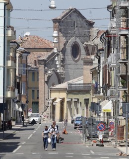 A view of a semi-collapsed church in Mirandola, northern Italy, is seen as people leave home, Tuesday, May 29, 2012. A magnitude 5.8 earthquake struck the same area of northern Italy stricken by another fatal tremor on May 20.  (AP Photo/Luca Bruno)